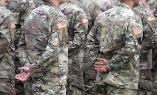 Military personnel in uniforms standing next to each other.