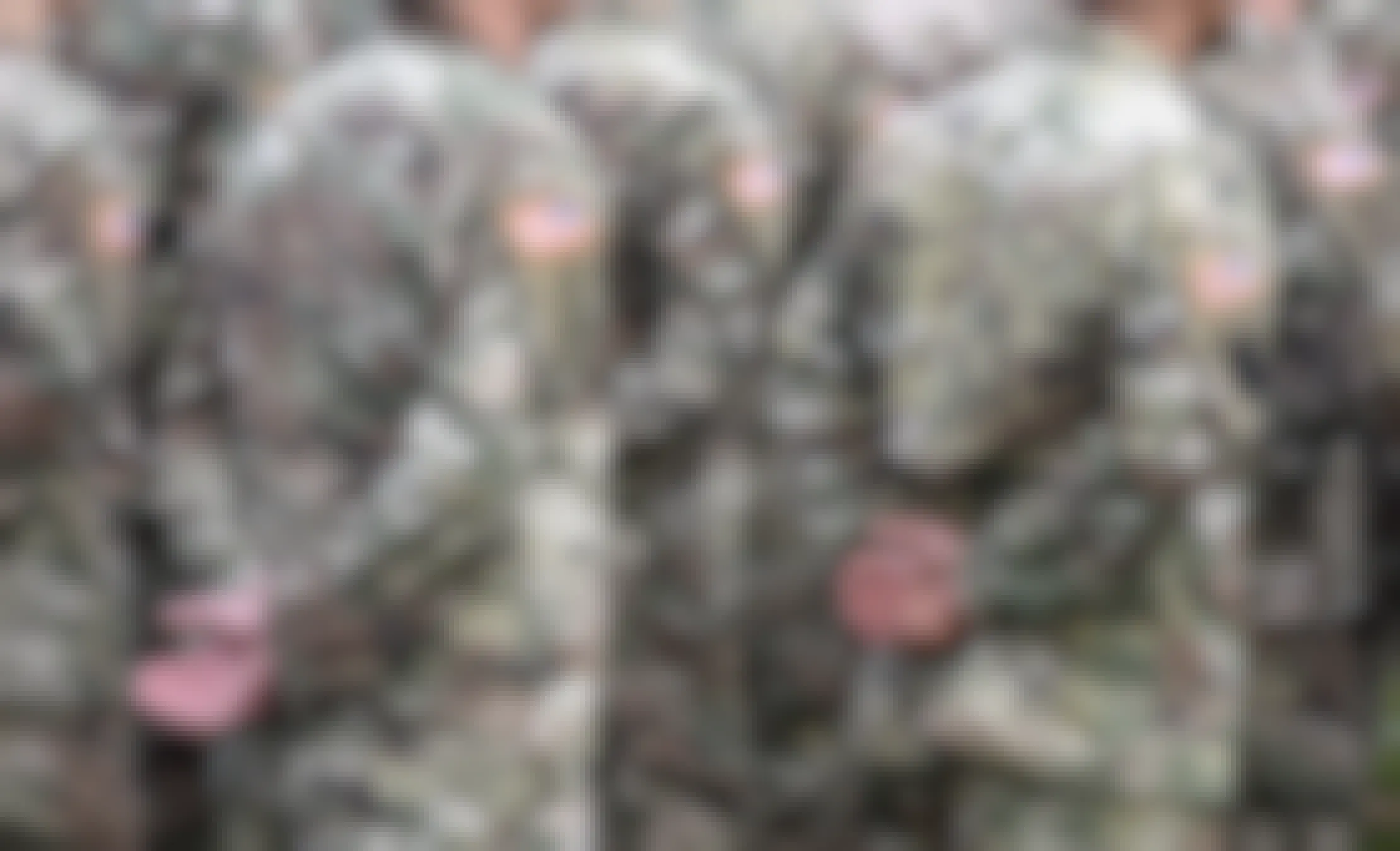 Military personnel in uniforms standing next to each other.