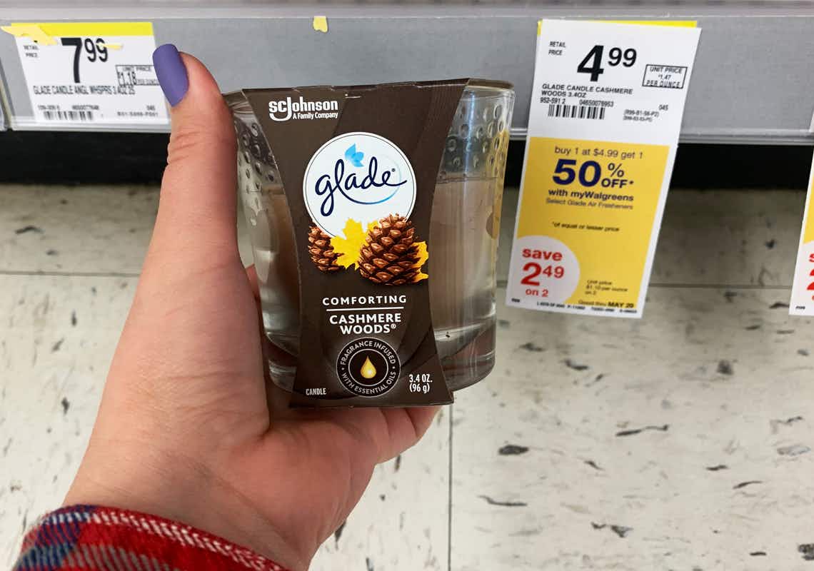 Glade candle next to a yellow sale tag indicating BOGO 50% off sale through May 29