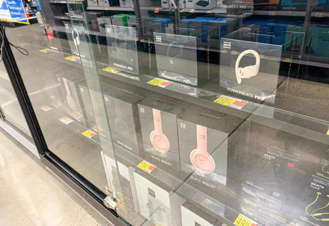 zoomed out photo of beats headphones in a glass case at walmart in the electronics department