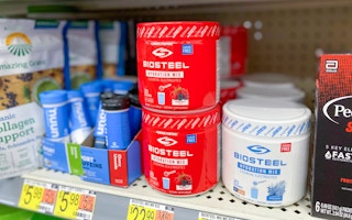 two bright red cans of biosteel hydration mix on walmart shelf photo taken from slight angle