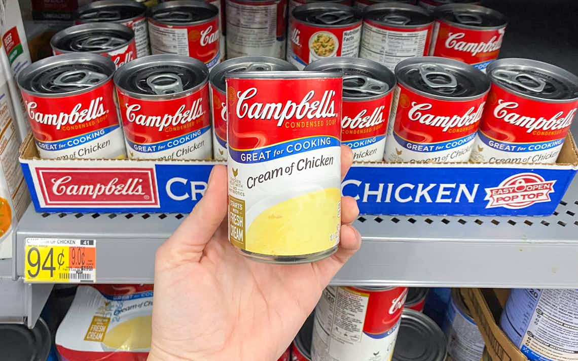 someone holding campbells soup at walmart
