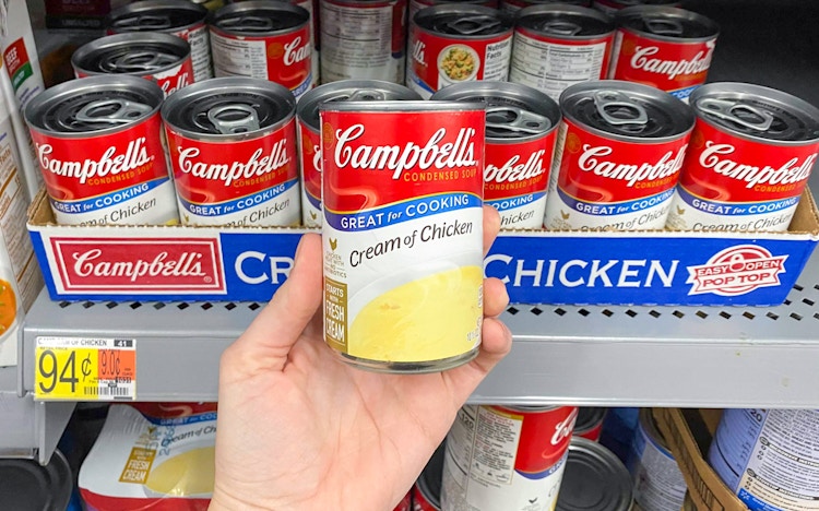 someone holding campbells soup at walmart