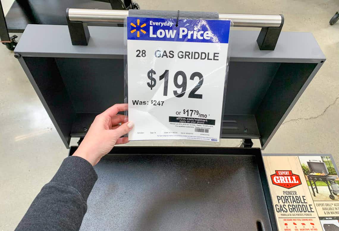 a close up of the walmart price tag for the expert grill pioneer portable propane gas griddle in a walmart store