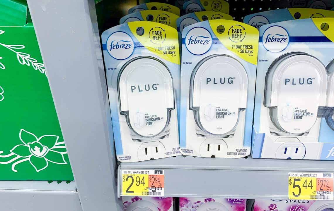 two febreze plug scented oil warmers next to each other on a walmart shelf with $2.97 price tag