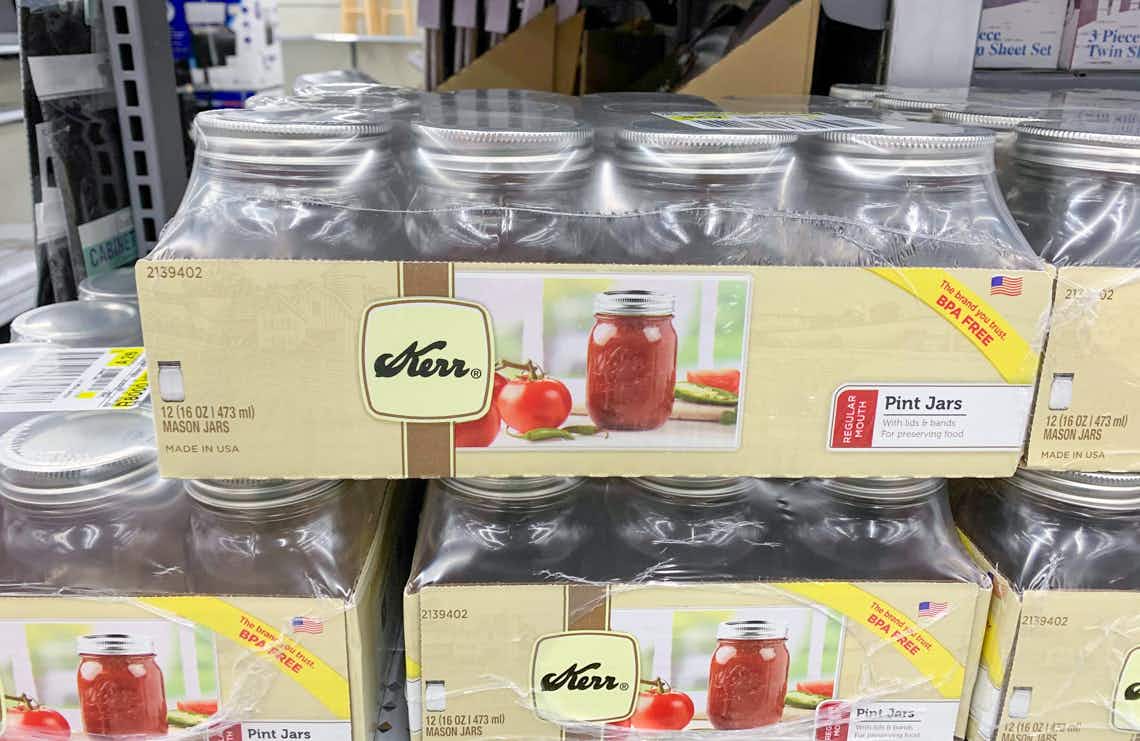 pack of 12 kerr pint sized canning jars sitting on a store shelf.
