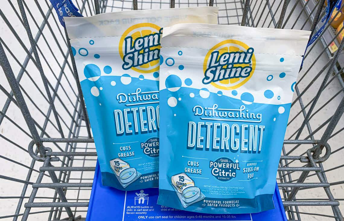 two bags of lemi-shine dishwasher detergent in a walmart cart with blue child seat