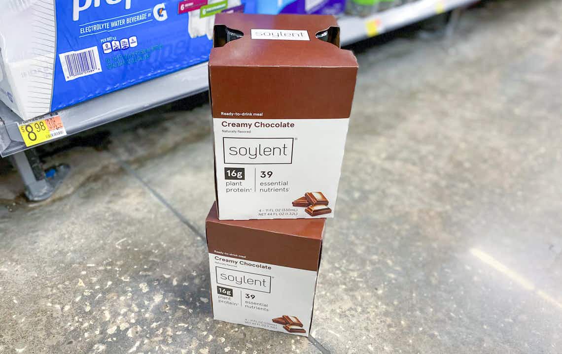 two chocolate soylent meal replacement drinks stacked on the floor at walmart