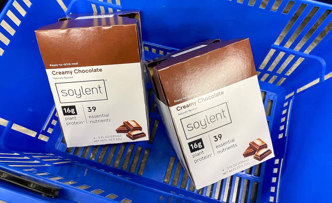 two boxes of chocolate soylent meal replacement drinks in a blue walmart hand basket