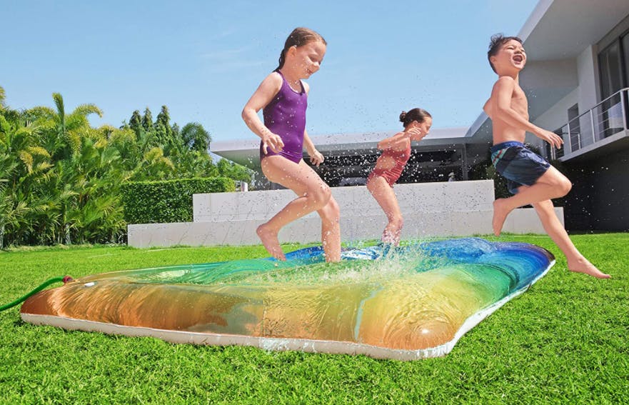 Kids running across a water blob