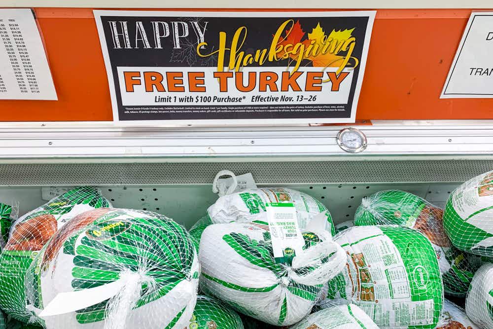 Frozen turkeys with a sign for a free thanksgiving turkey