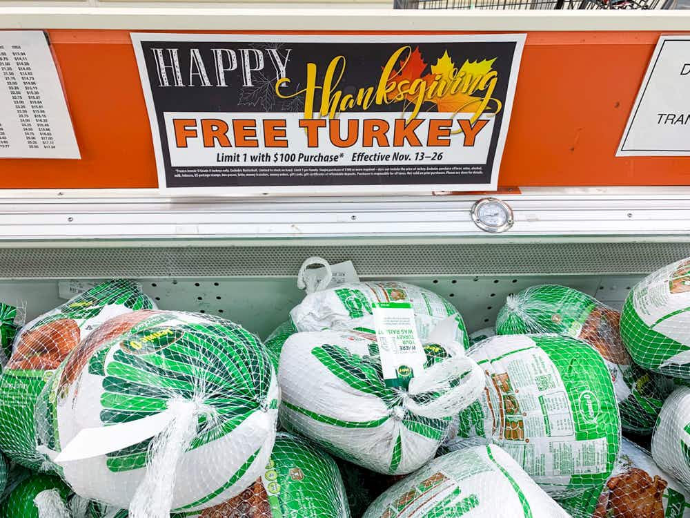 Frozen turkeys with a sign for a free thanksgiving turkey