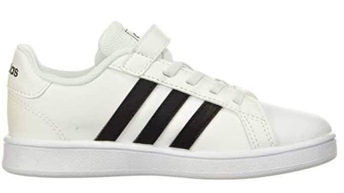 One white Adidas kids-sized shoe with black stripes