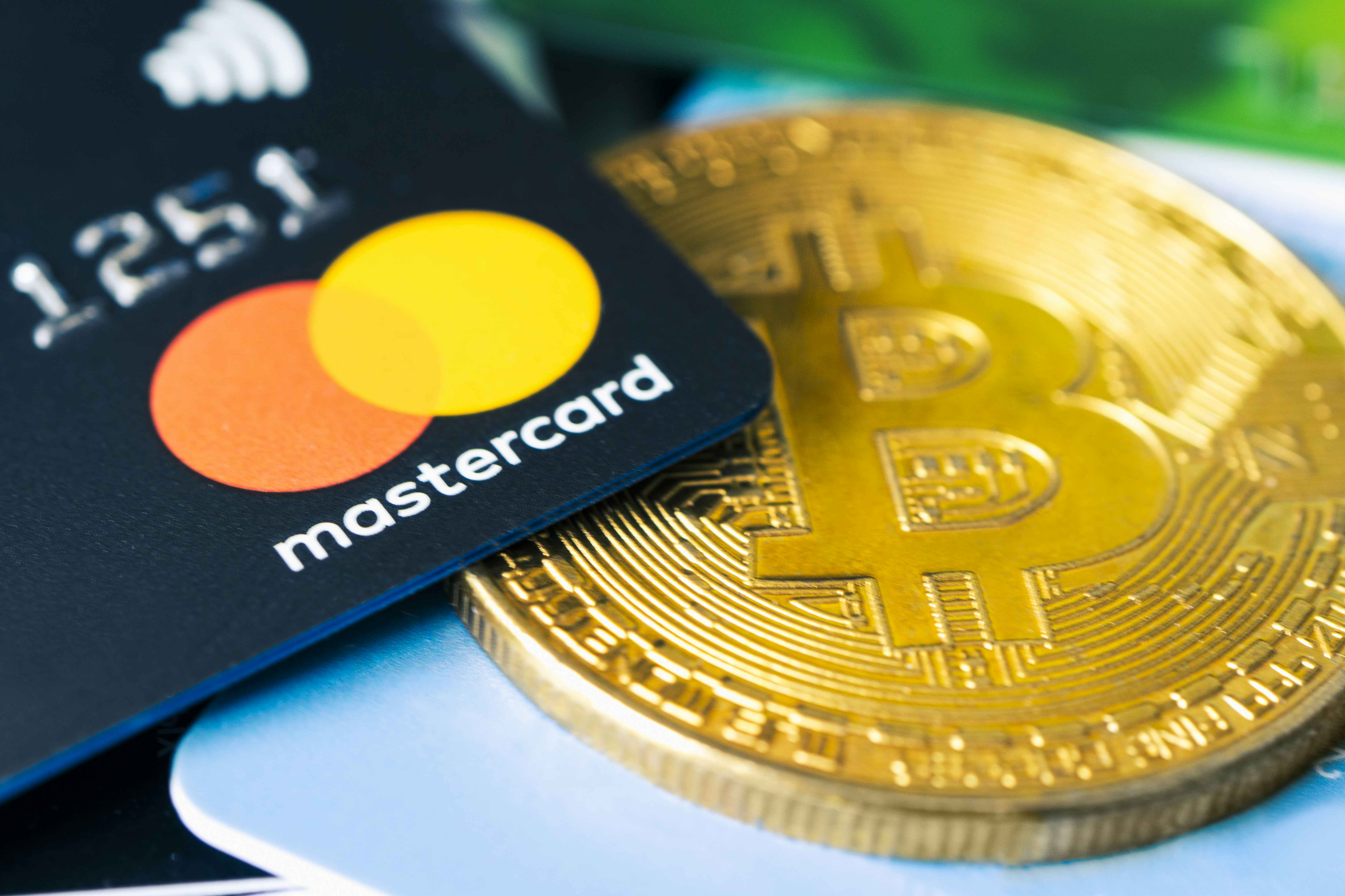 mastercard is sitting on top of a bitcoin