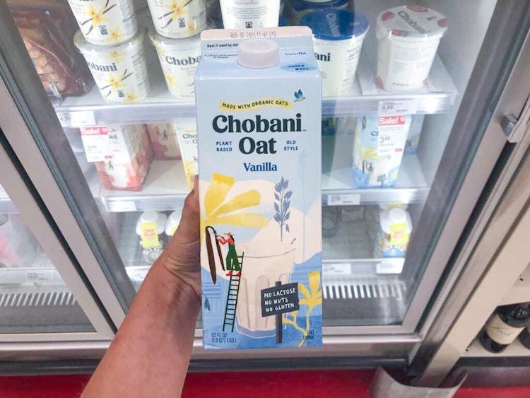 hand holding a carton of chobani oatmilk at target