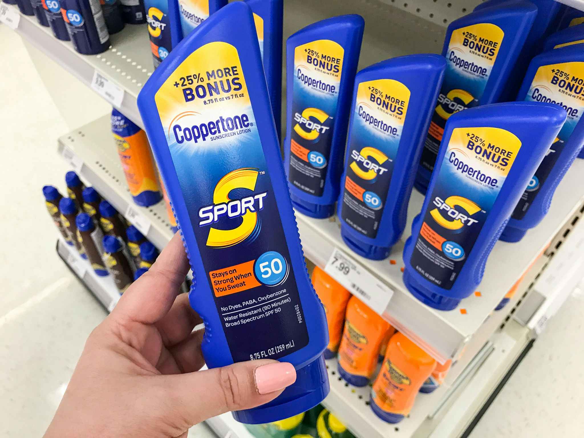 hand holding a bottle of coppertone sunscreen at target