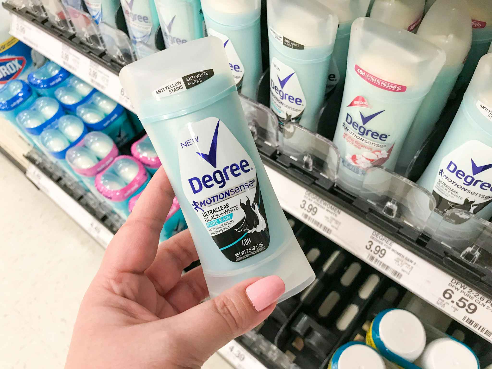 hand holding degree deodorant in front of target shelf