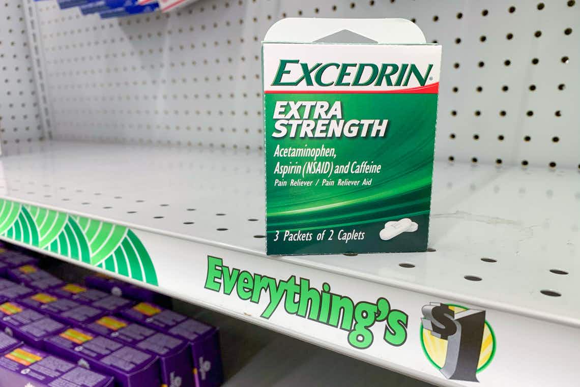 small green and white pack of excedrin extra strength tablets on a dollar tree shelf with a banner saying "everything's $1