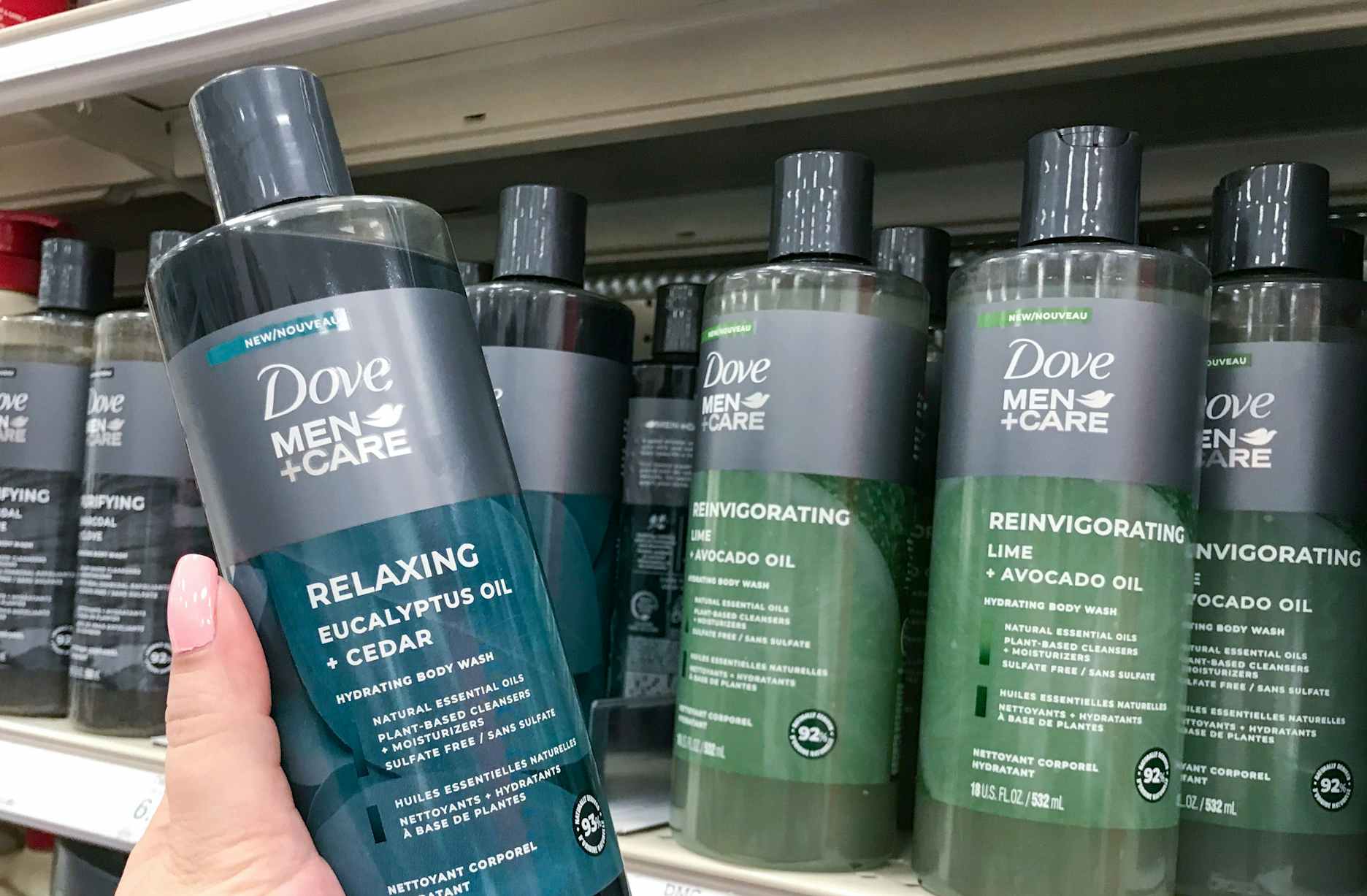 hand holding a bottle of dove men+care body wash in front of traget shelf