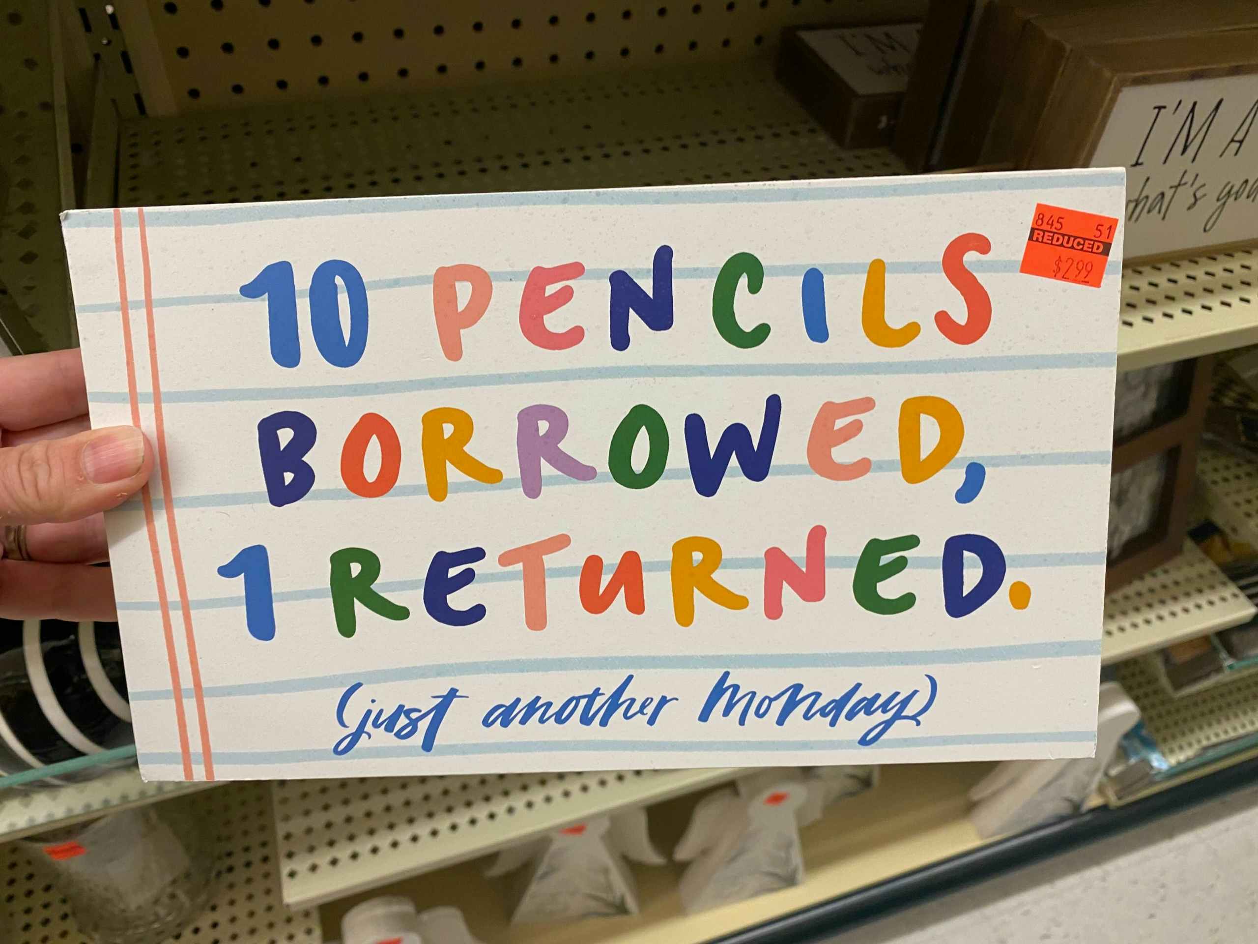 signage saying 10 pencils borrowed 1 return in rainbow letters