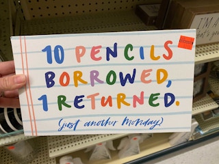 signage saying 10 pencils borrowed 1 return in rainbow letters