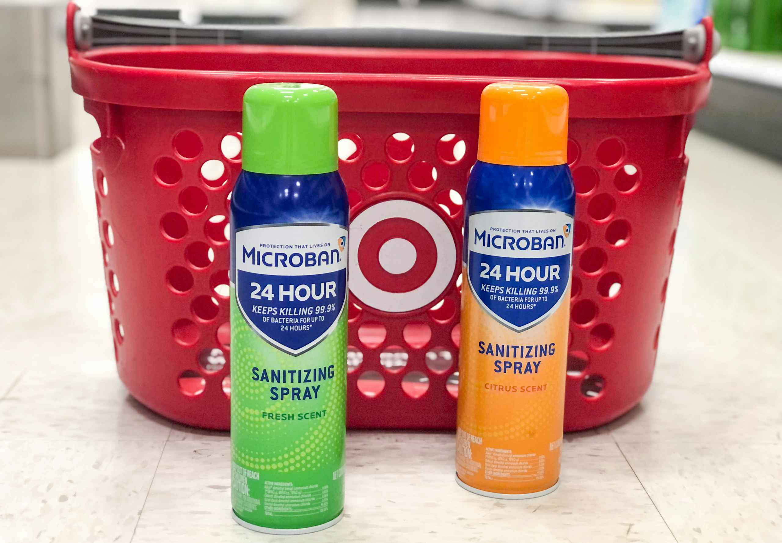 two bottles of Microban on the floor in front of a Target basket
