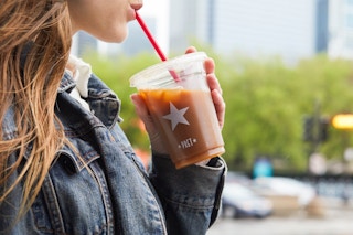 Woman drinking Pret a Manger iced coffee