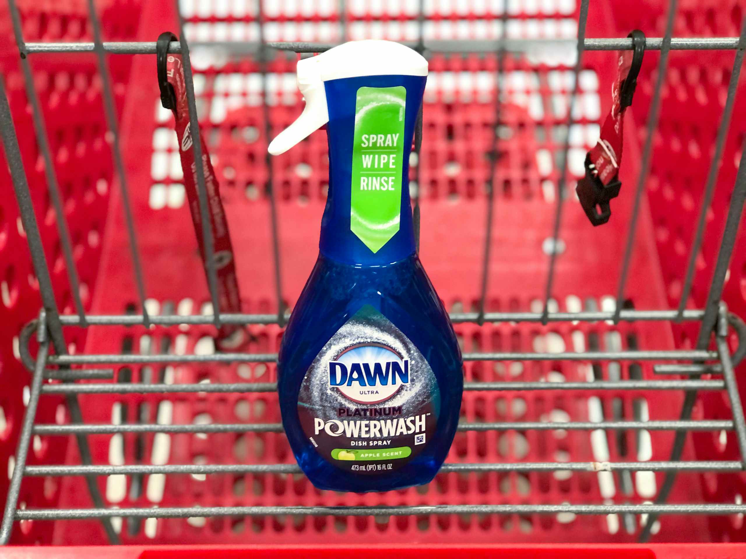 hand holding bottle of Dawn in front of store soap display