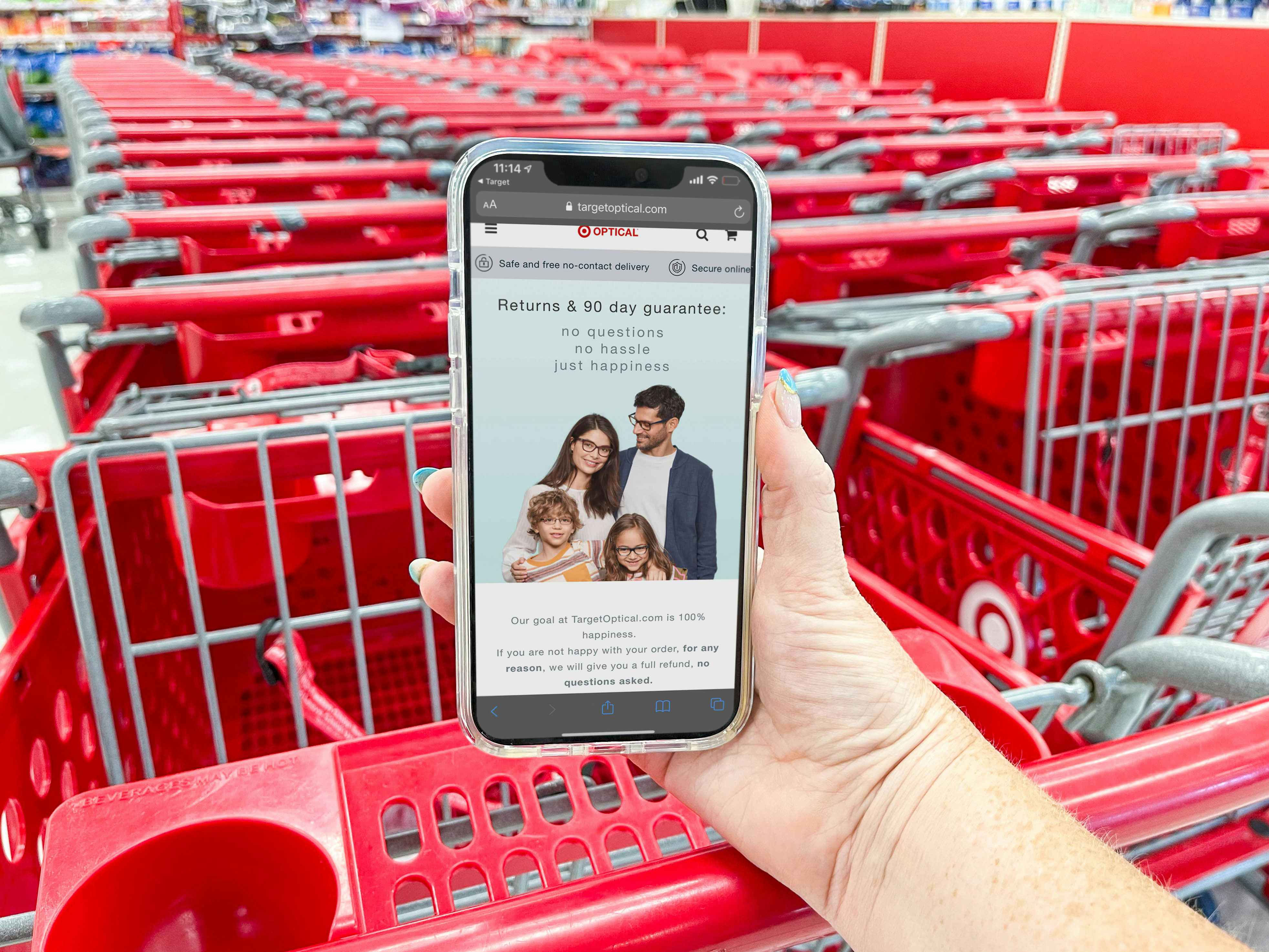 hand holding cellphone with target app with optical return policy in store in front of carts