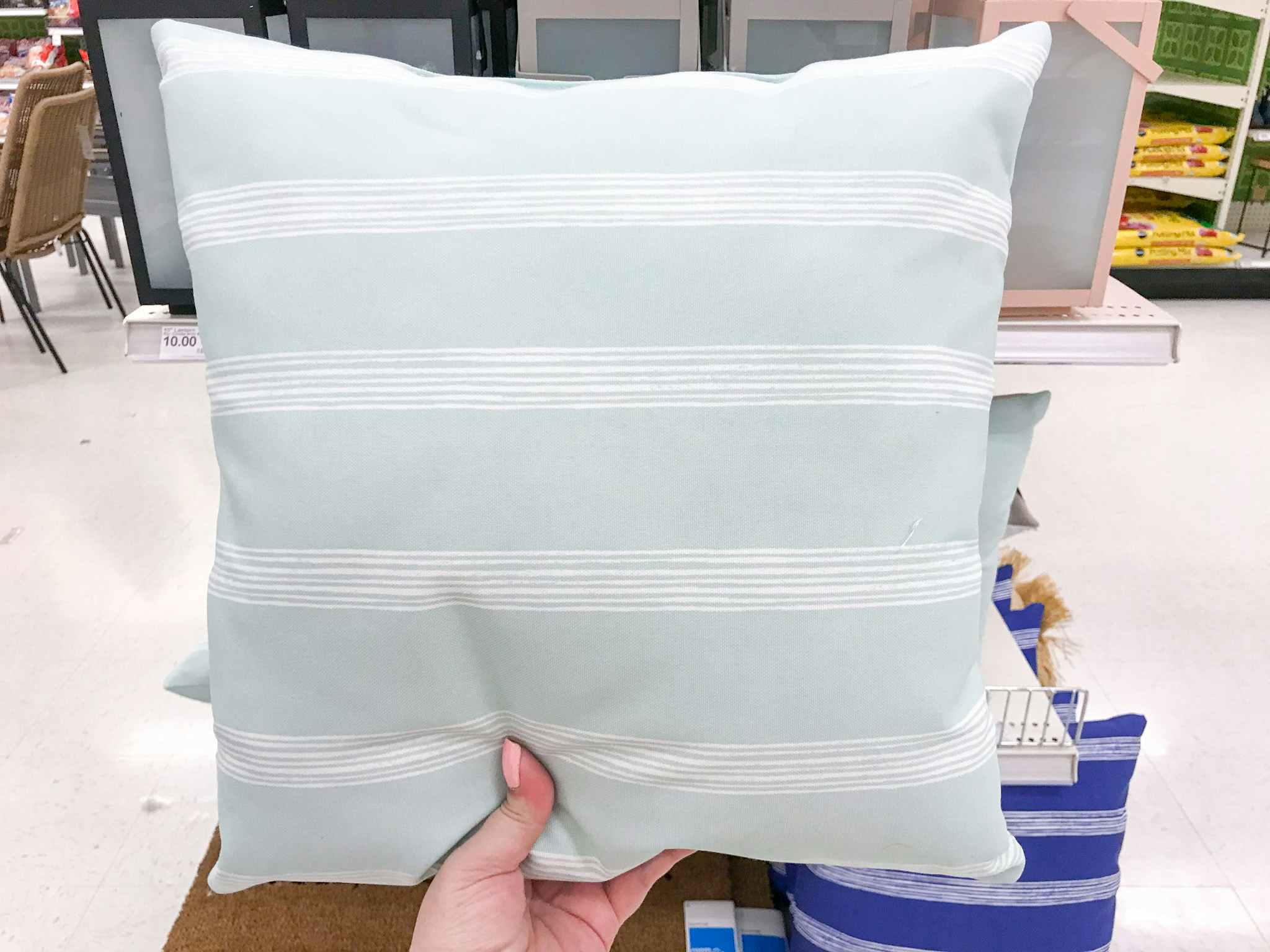 hand holding a throw pillow at target