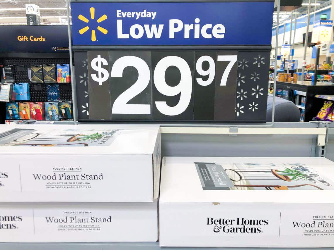walmart everyday low price sign above better homes and gardens wood plant stands in white boxes