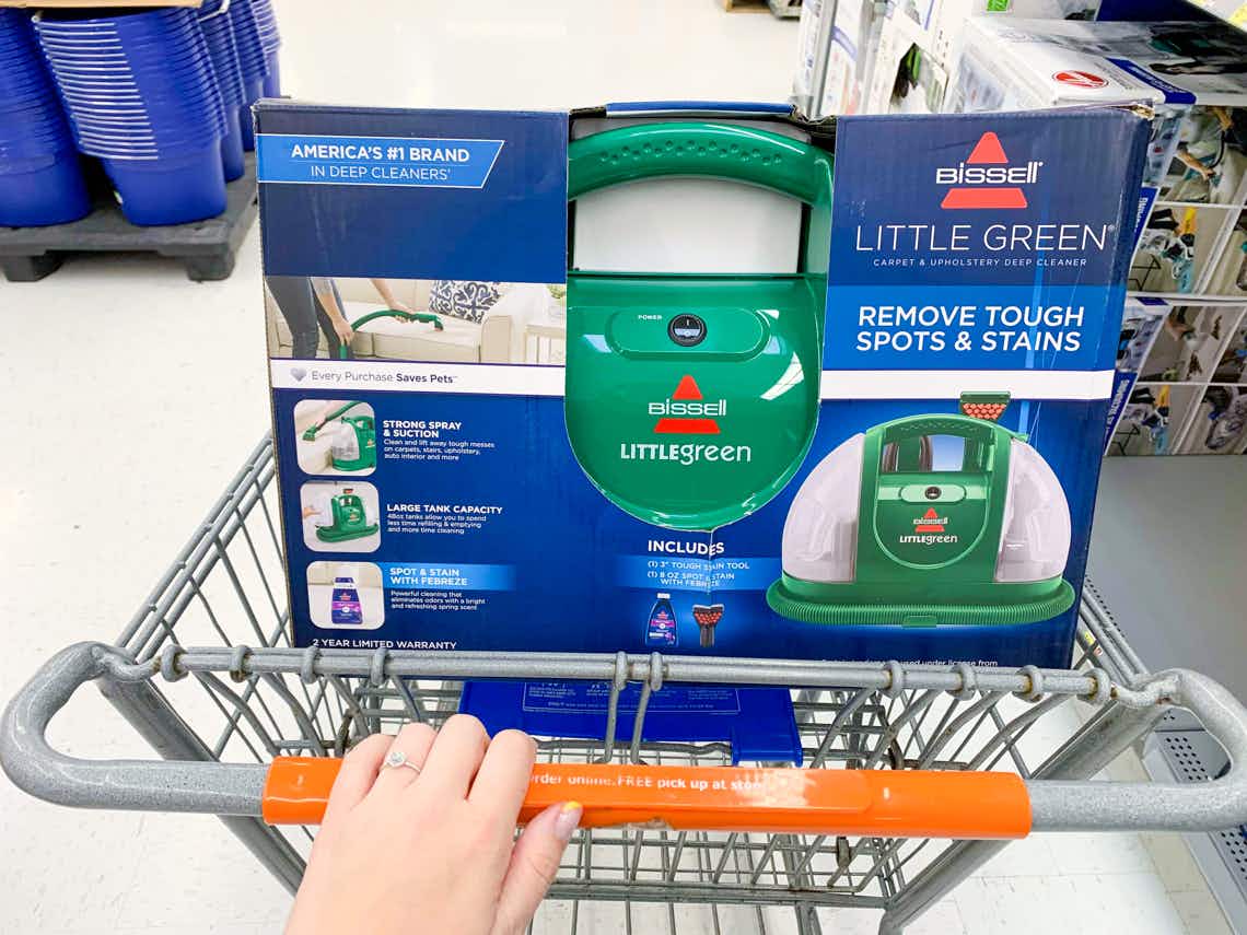 bissell little green machine in box in walmart cart with hand pushing cart