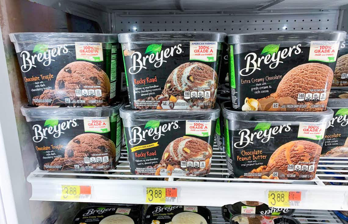 six containers of breyers ice cream in various flavors on a walmart freezer shelf
