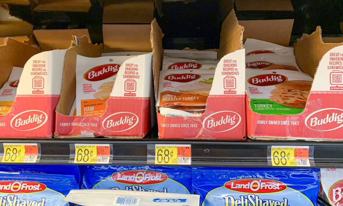 a row of buddig sliced lunch meat in boxes on walmart shelf