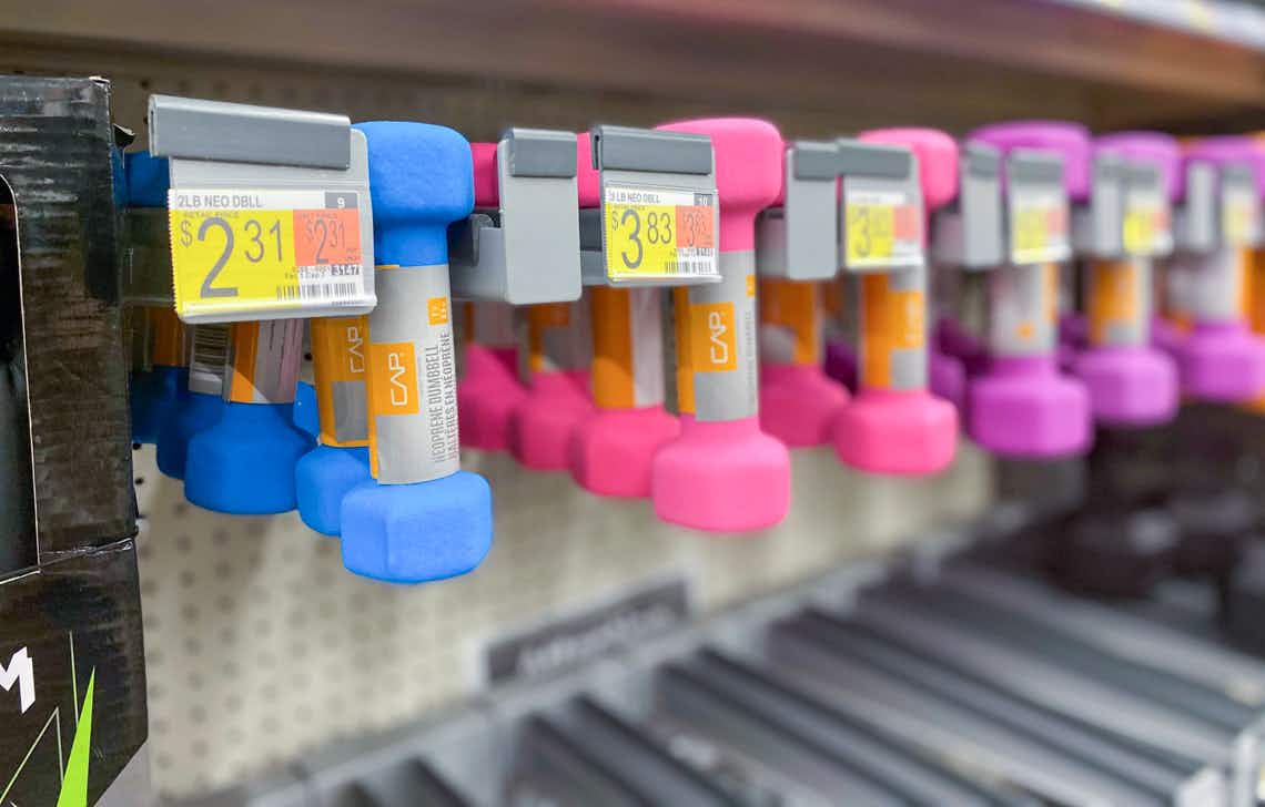 cap neoprene dumbbells hanging on a walmart pegboard display with price tags