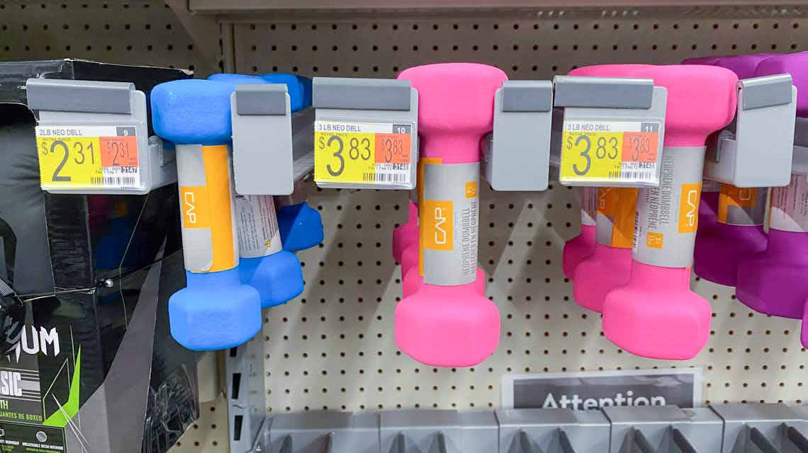 pink three pound cap neoprene dumbbells handing on walmart wall with price tags
