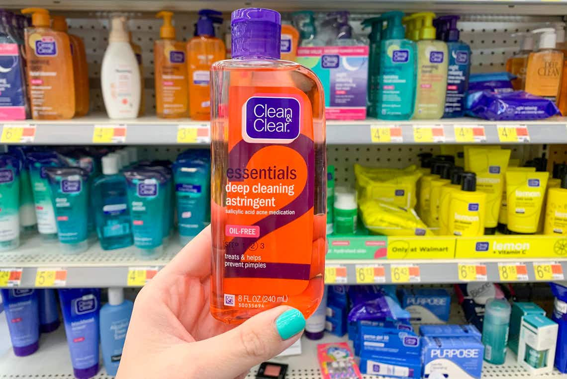 bottle of clean and clear held in front of walmart skin care aisle