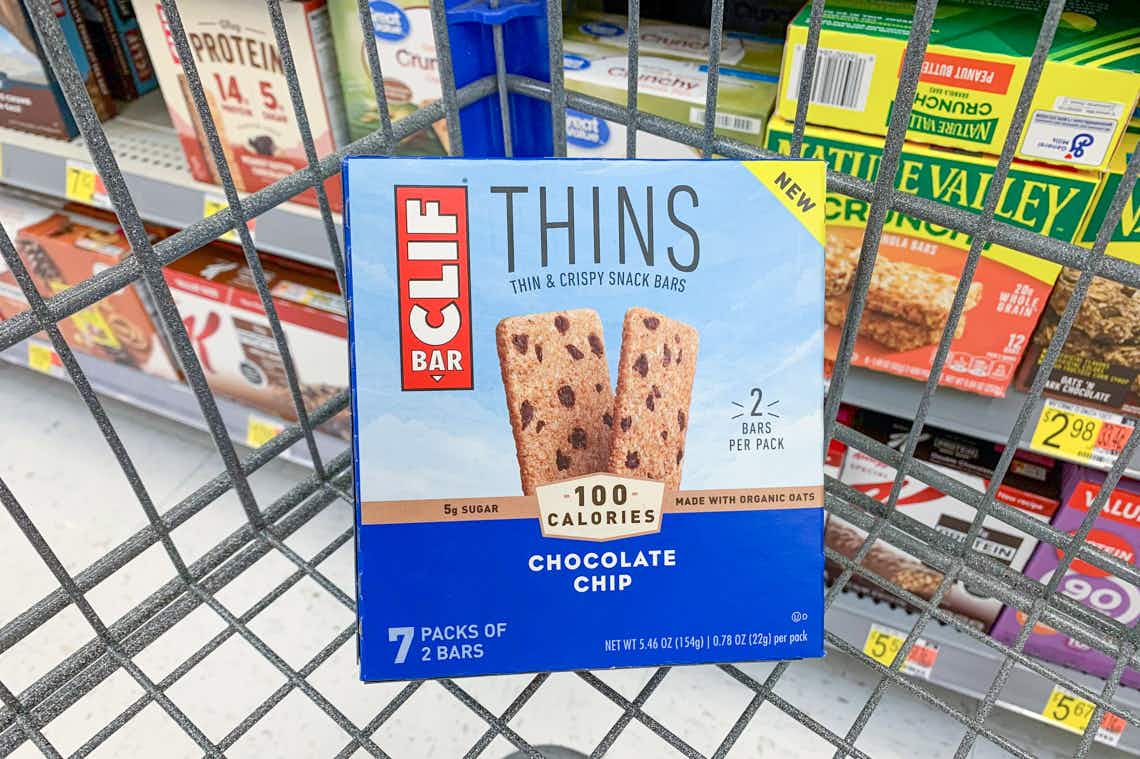 clif bar thins chocolate chip flavor box propped up in a walmart cart corner in front of other granola bars on shelves