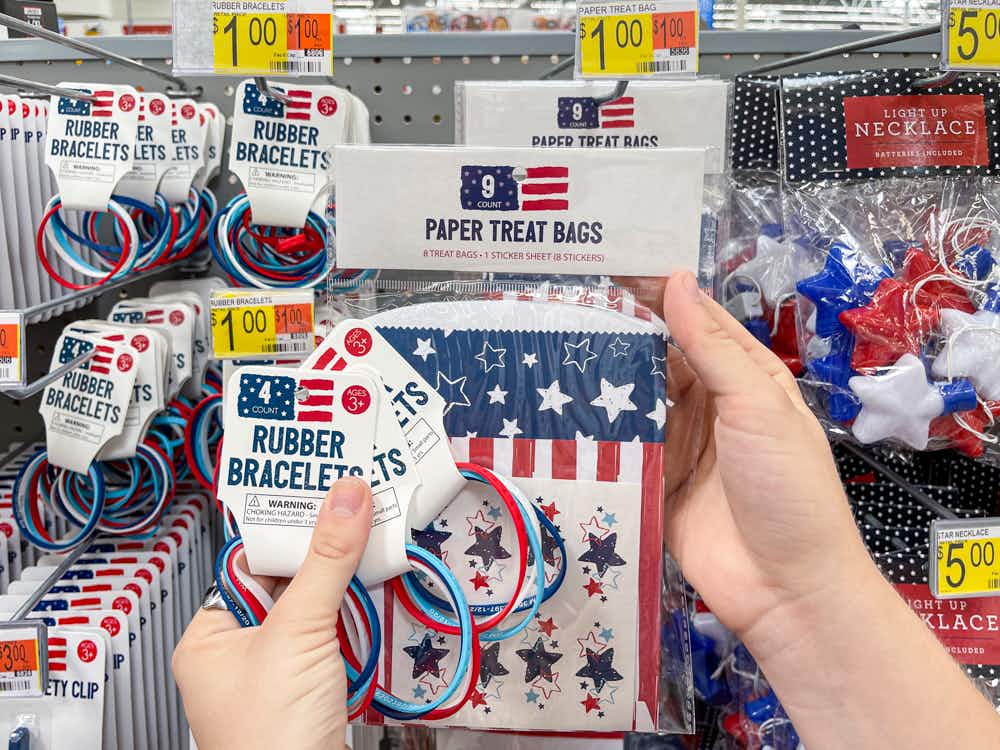 4th of July products held in front of a shelf 