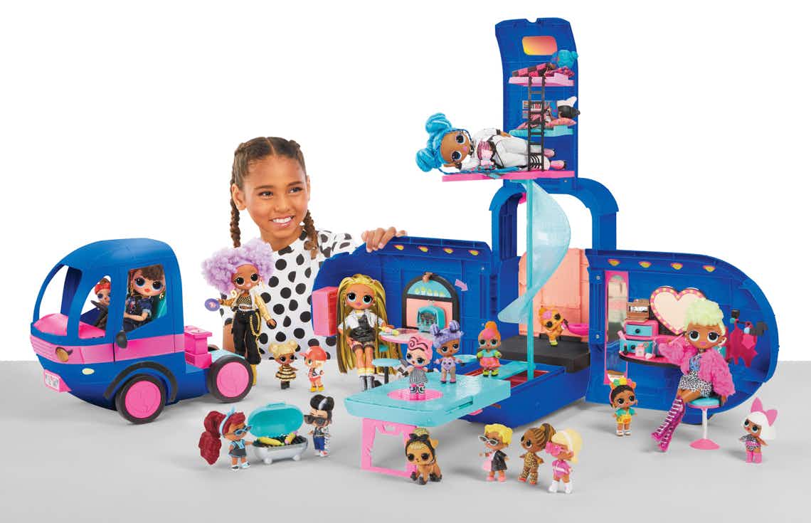 stock photo of girl playing with l.o.l. surprise glamper fashion camper and accessories
