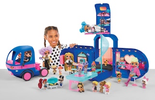 stock photo of girl playing with l.o.l. surprise glamper fashion camper and accessories
