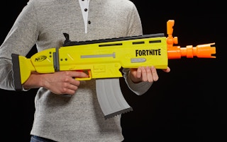 stock photo of guy holding nerf fortnite dart blasteron black background