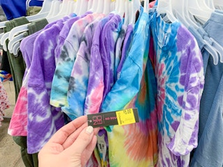 no boundaries tie dye tee shirts on walmart circular rack with clearance tag held by hand to show price