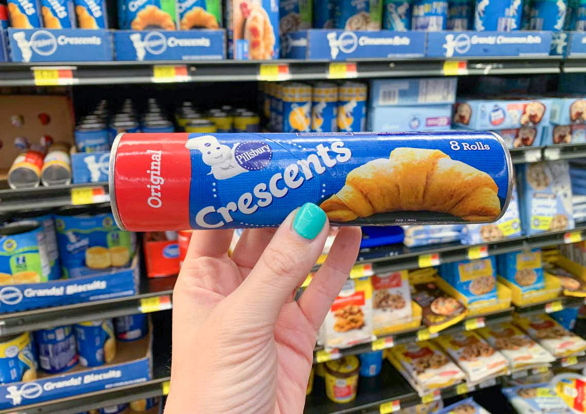 tube of pillsbury crescent rolls held in front of other pillsbury products at walmart