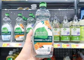 bottle of seventh generation dish soap held in front of other bottles of seventh generation dish soap