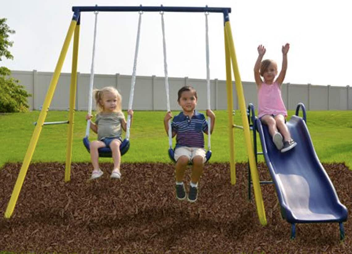 stock photo sportspower swingset with kids playing in yard or playground