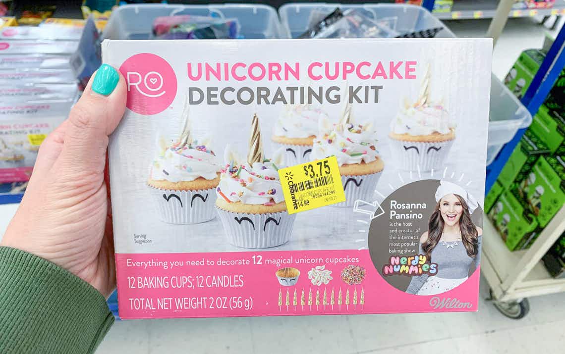 hand holding wilton R O unicorn cupcake decorating kit with clearance sticker