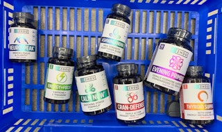 zhou nutitrion health supplements in a blue walmart basket with floor as backgroun