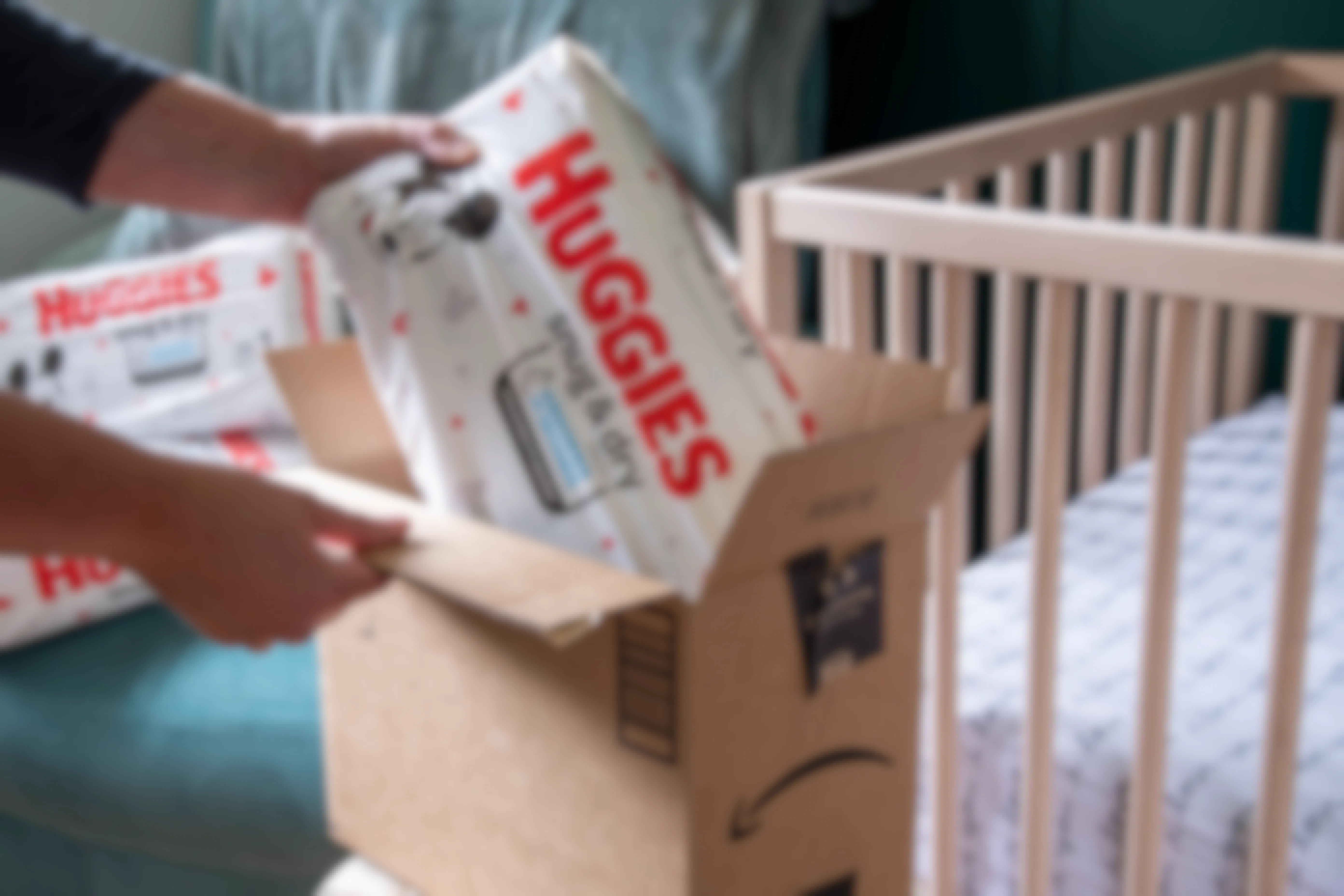 A pack of Huggies diapers being pulled from an Amazon box.