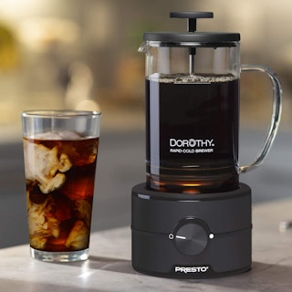 A Presto coffee cold brewer next to a cup of coffee.